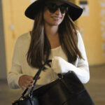 Lea Michele heads out of an office building with a friend in Los Angeles